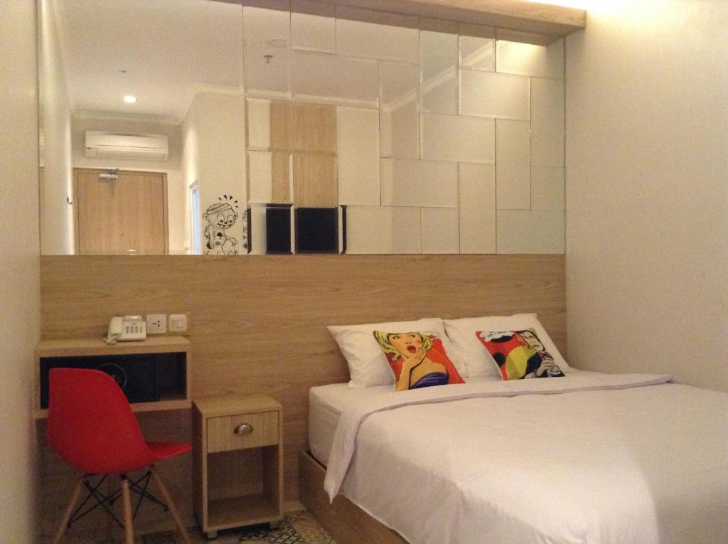 Postel nebo postele na pokoji v ubytování Bold Hotel Jakarta
