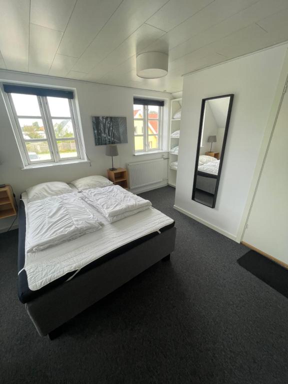 a bedroom with a bed and a large mirror at Øster Hurup Camping in Hadsund