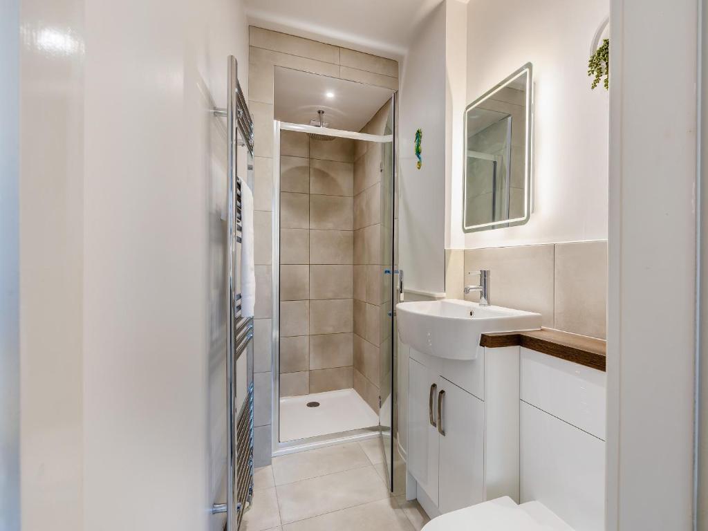 a white bathroom with a sink and a shower at Sand Dune - Uk48699 in Lancaster