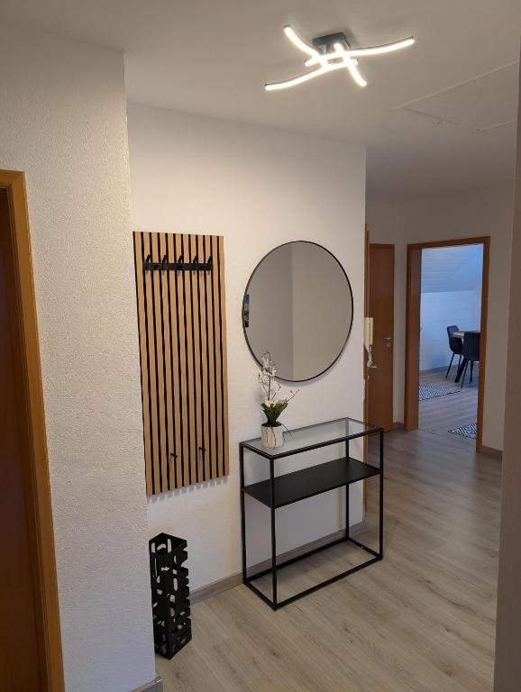 a living room with a mirror and a table at Bauers Ferienwohnung in Wabern