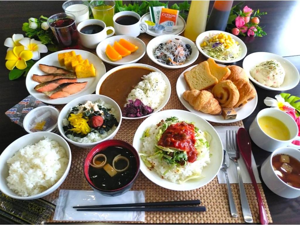 a table with many plates of food on it at Smile Hotel Okinawa Naha - Vacation STAY 04111v in Naha