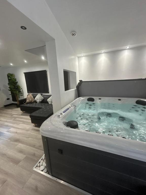 a large bath tub in a living room at The Sauna House in Stockbury
