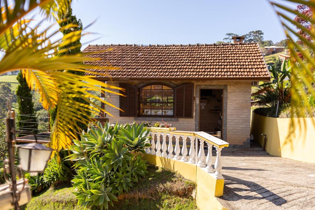 a small house with a staircase in front of it at Chalés São Francisco II in Santo Antônio do Pinhal