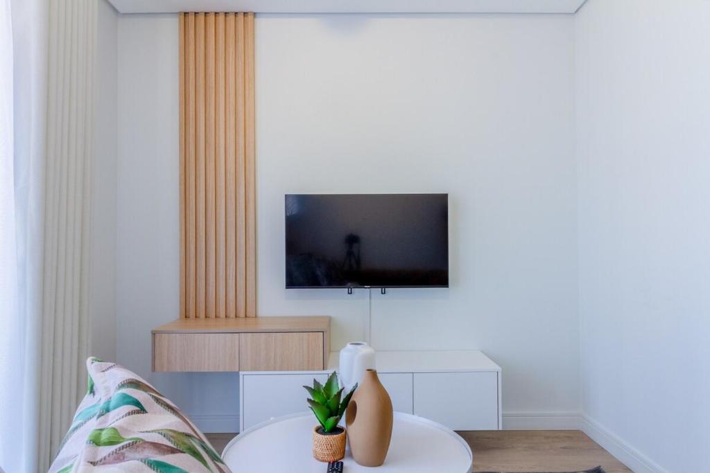Vosburgにある#AlimamaSpaces The Chelsea's Cassini Ellipseのテレビとテーブルのあるリビングルーム