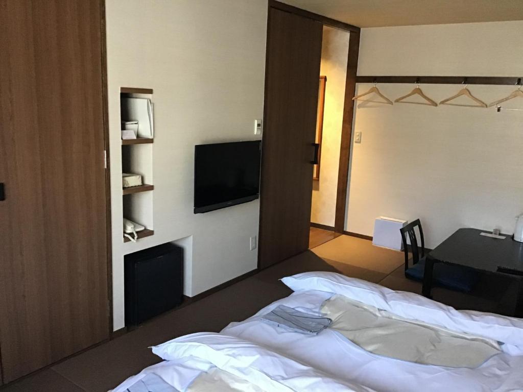 a hotel room with a bed and a television at K,M,H Art hotel by Kure Morisawa - Vacation STAY 11399v in Kure