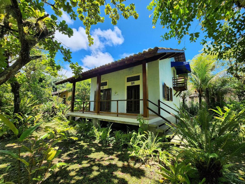 a small house in the middle of a forest at Chalés Villa do Mar in Ubatuba