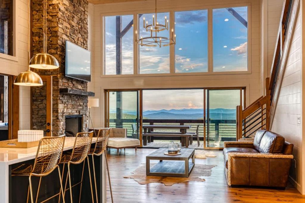 a living room with a fireplace and a large window at Big Sky - Best Views in Blue Ridge in Epworth
