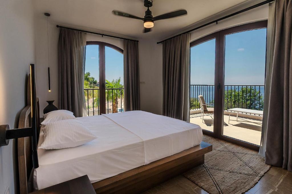 a bedroom with a large bed and a balcony at Zorka in Budva
