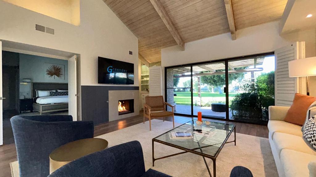 a living room with a couch and a fireplace at Racquet Club Retreat Modern Luxe Living in a Peaceful Desert Escape – managed by Greenday in Rancho Mirage