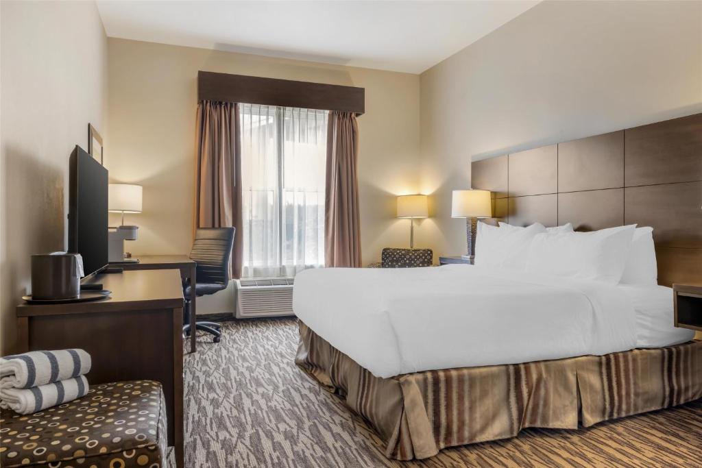 a hotel room with a large bed and a desk at Best Western Plus Bridgewater Hotel & Convention Centre in Bridgewater