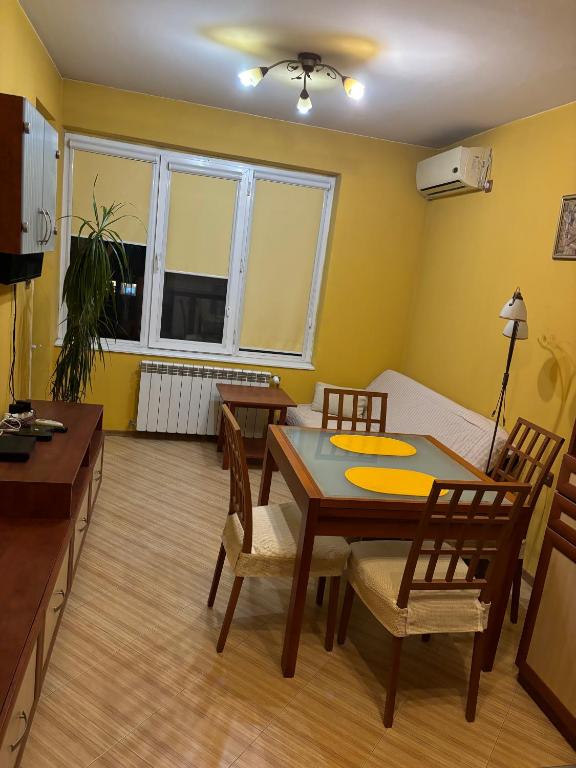 a living room with a dining room table and chairs at Galina apartment in Ruse