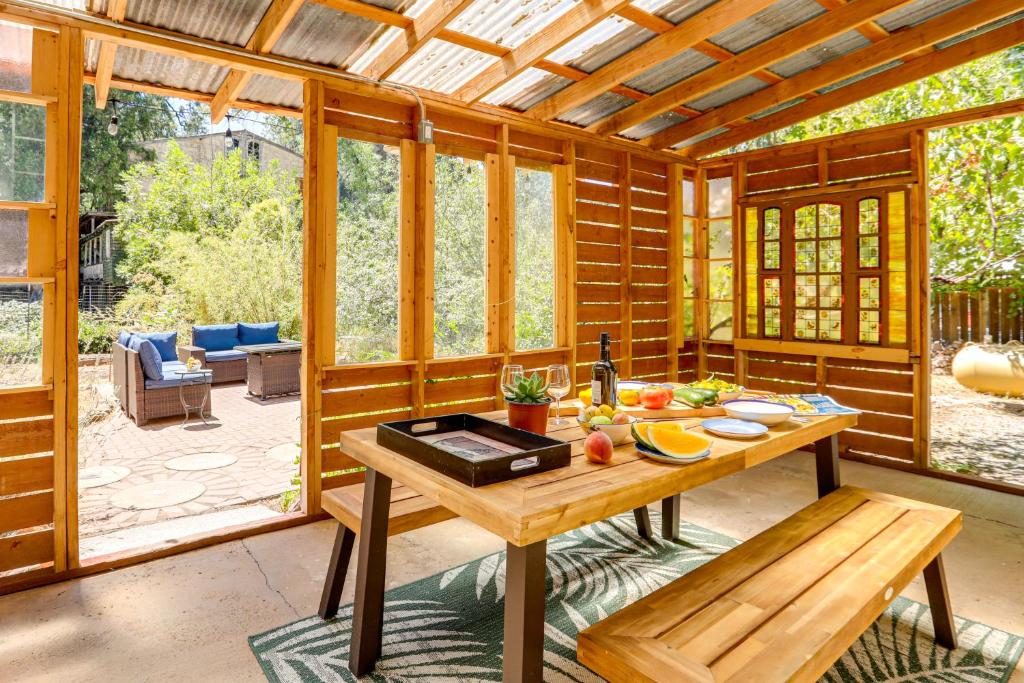 a kitchen with a table in a room with windows at Wine Country Cottage in Historic Fiddletown! in Fiddletown