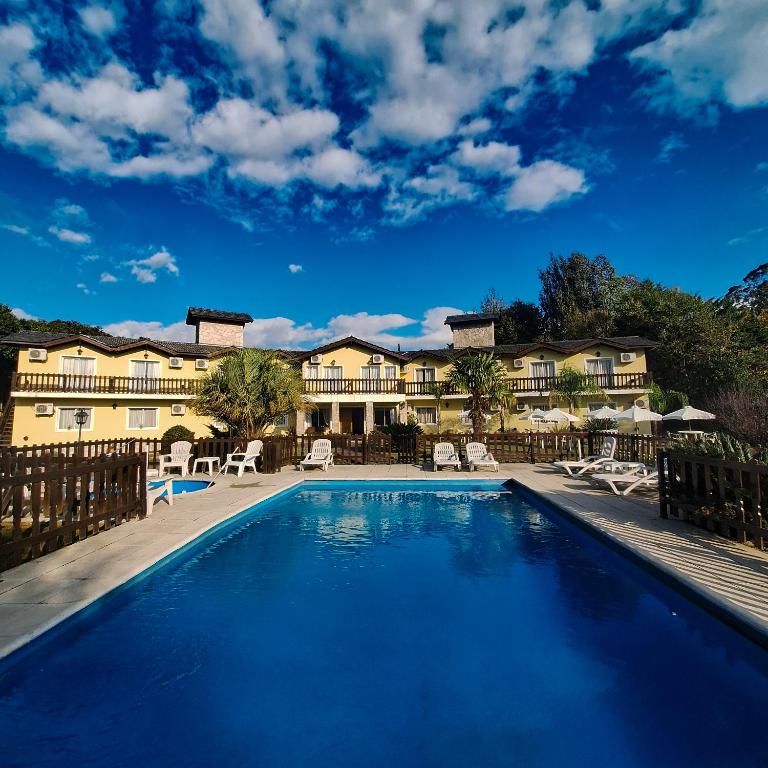 a swimming pool in front of a resort at Posada Yumei in Villa General Belgrano