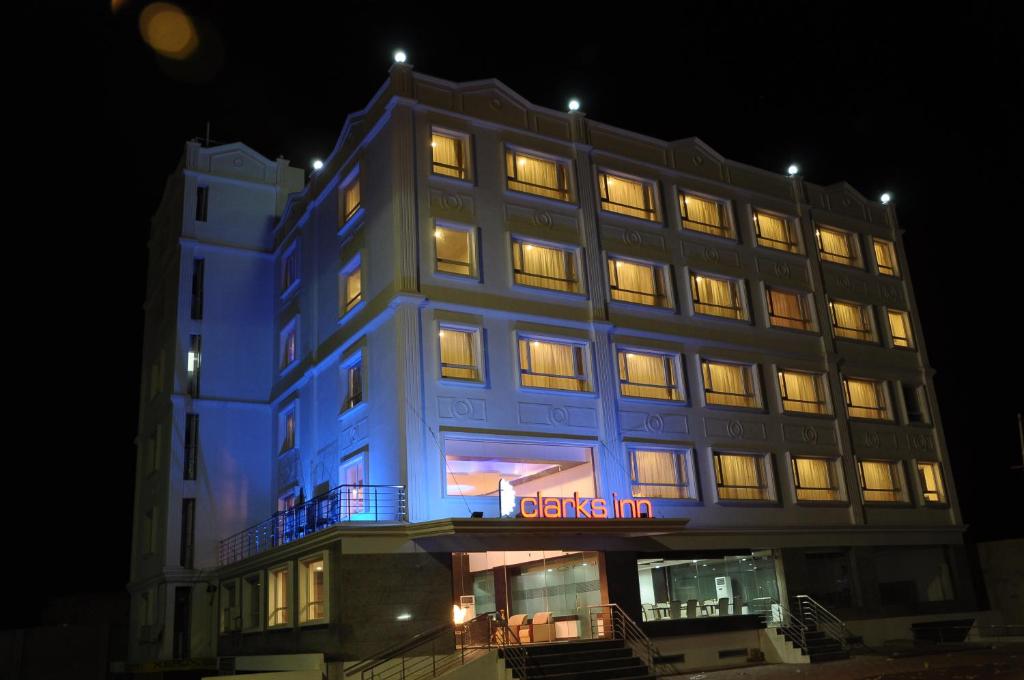 a lit up building with a blue lit up at Grand Clarks Inn in Badami