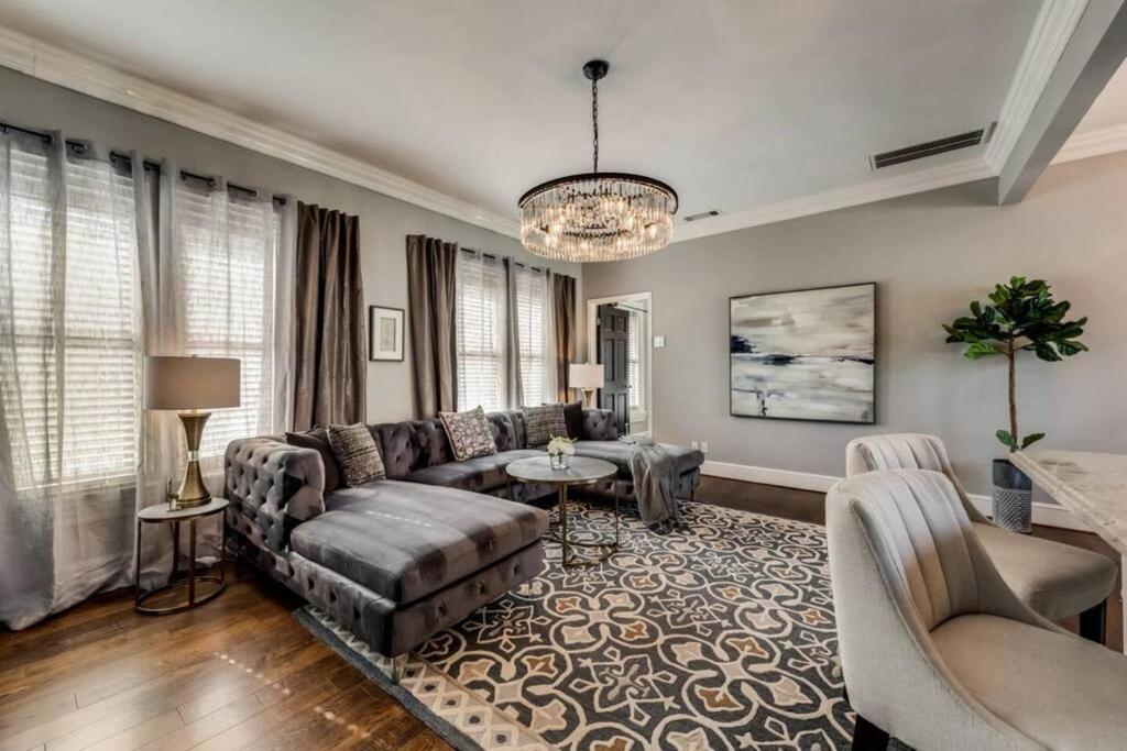 a living room with a couch and a table at Enchanting 1br Retreat Tree-lined Swiss Ave in Dallas