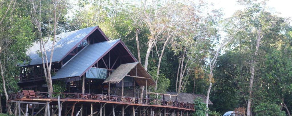 una casa con techo de metal en el bosque en Borneo Natural Sukau Bilit Resort en Bilit