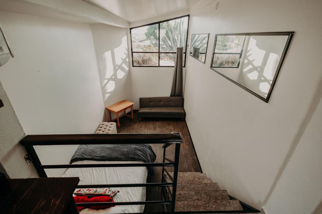 a room with a staircase with a bed and a chair at DaNik Valle in Francisco Zarco