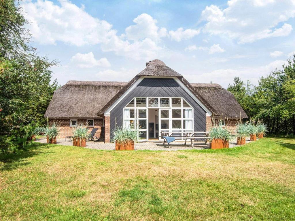 a barn style house with a thatched roof at 10 person holiday home in Nørre Nebel in Nørre Nebel