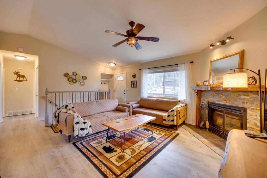 a living room with a couch and a fireplace at Comforting Woodland Park Home with Fire Pit! in Woodland Park