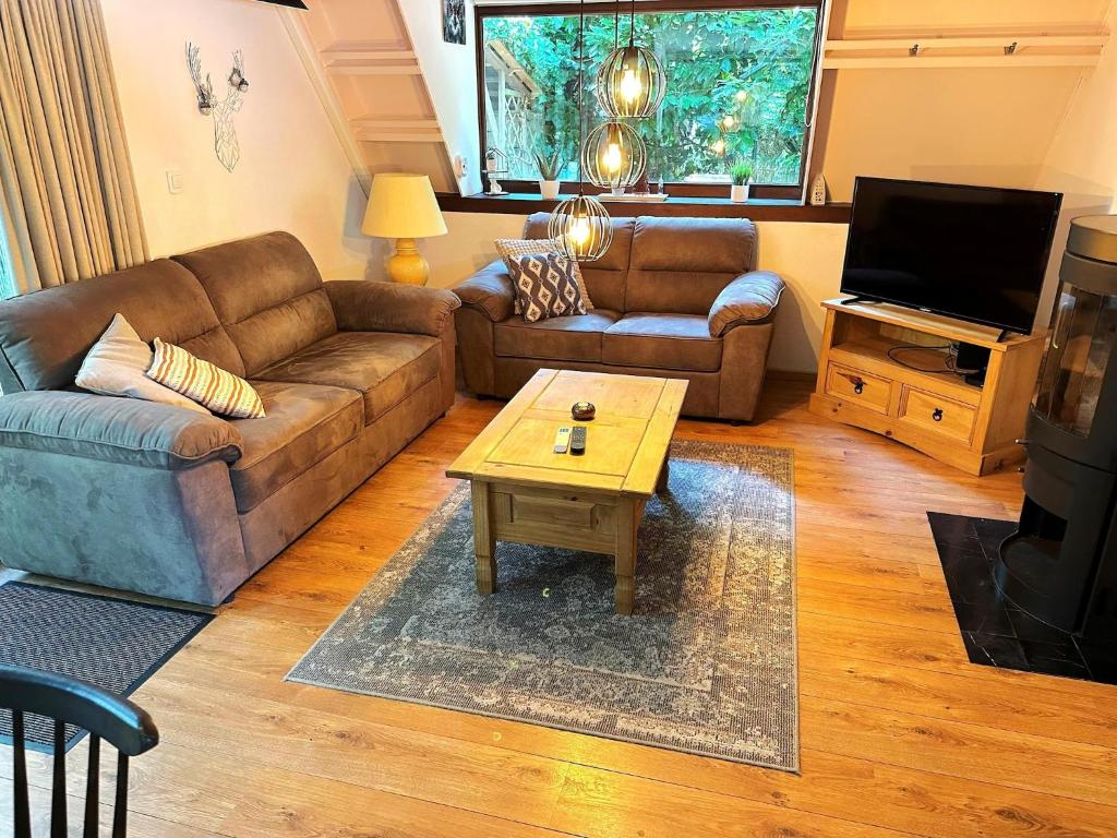 a living room with a couch and a coffee table at Lanaken Luxe Garden Retreat in Lanaken
