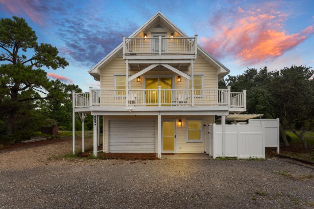a house with a balcony on the side of it at Ft Morgan Bama Belle-Beach Access in Gulf Shores