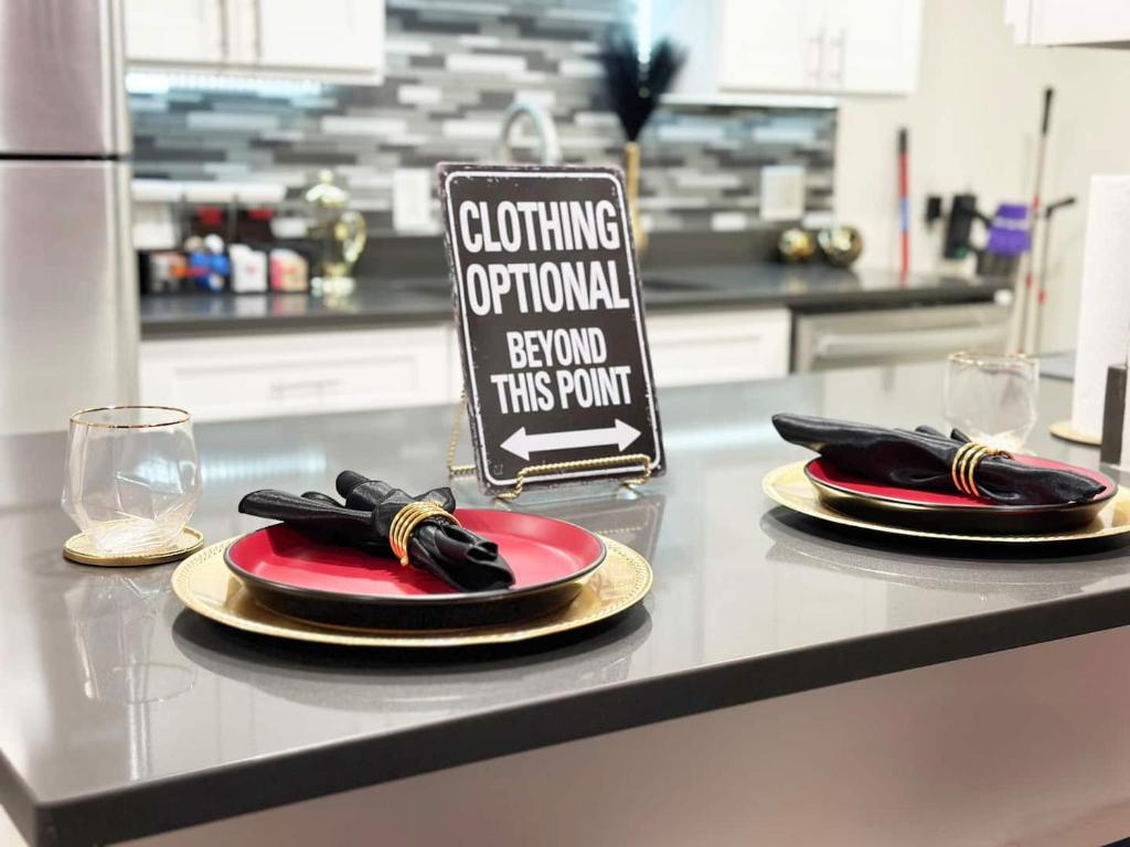 a kitchen counter with two plates and a sign on it at Romantic Hot Tub Escape Discreet & Private in Tucson