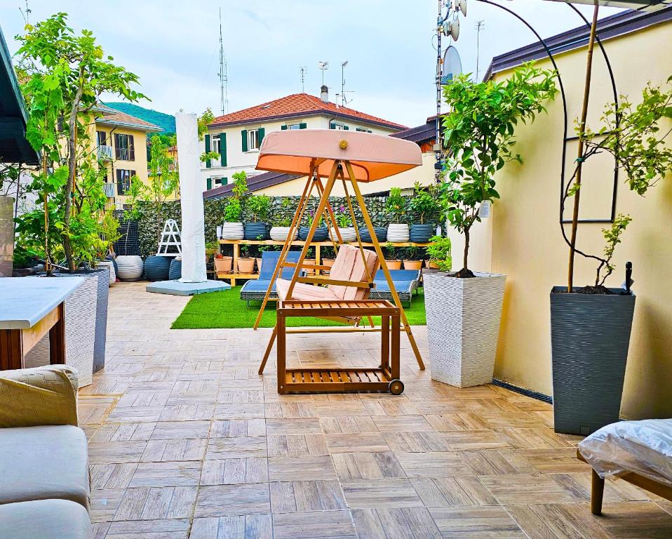 a patio with a chair and an umbrella at Casa Bianca Luino Terrace View in Luino