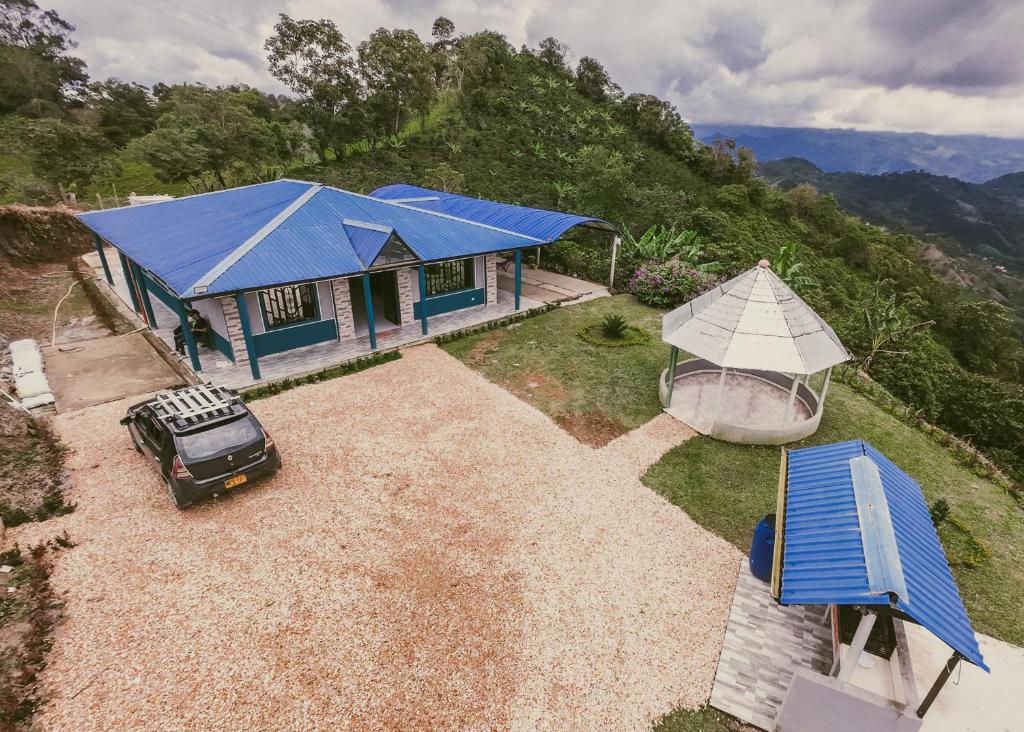 an aerial view of a house with a blue roof at Rancho Buenavista in Vergara