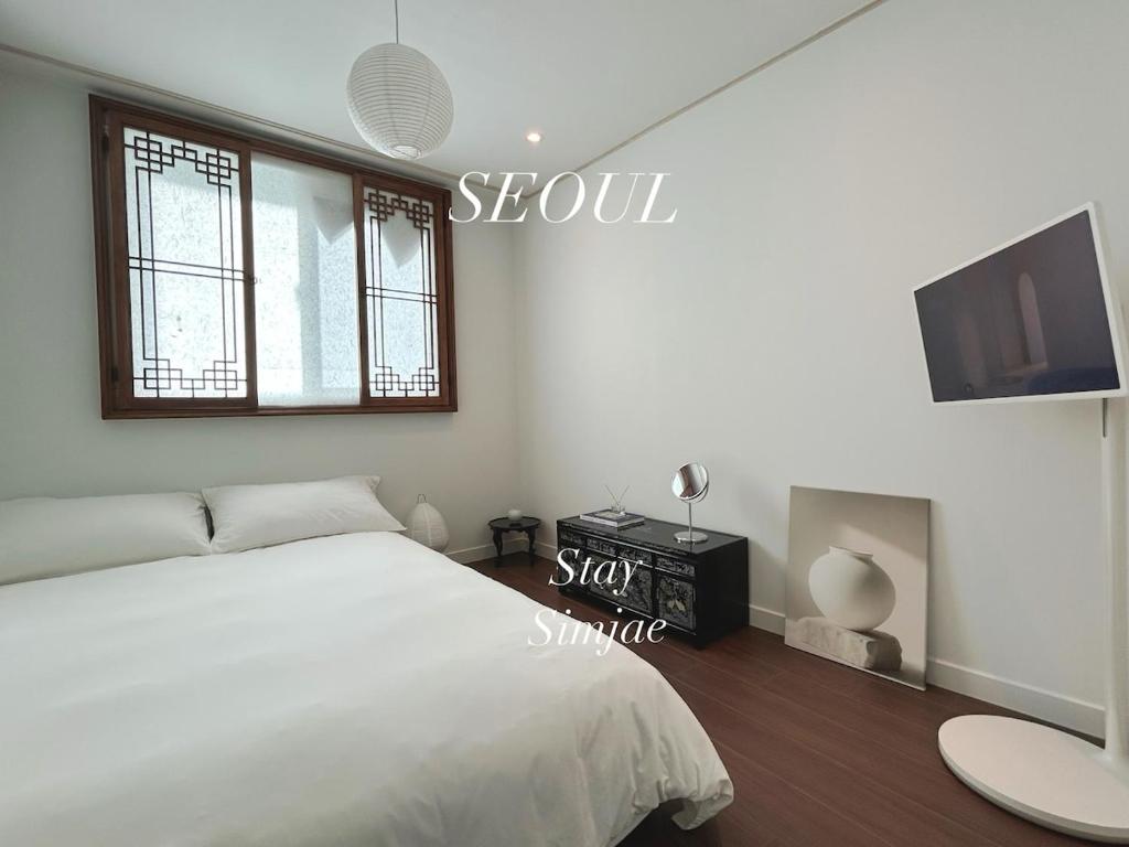 a bedroom with a bed and a flat screen tv at Seoul Station Hanok concept in Seoul