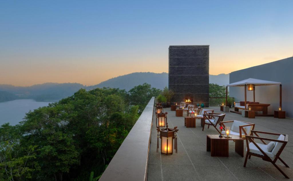 a rooftop patio with tables and chairs and a fireplace at The Lalu Sun Moon Lake in Yuchi