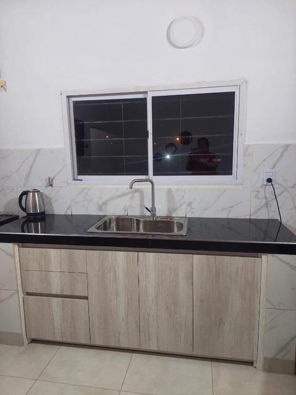 a kitchen counter with a sink and a window at Nat depto in Senillosa