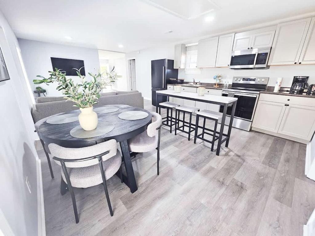 a kitchen and dining room with a table and chairs at 5 Min to Elon - In Unit Washer and Dryer - Fast Wi-Fi in Burlington