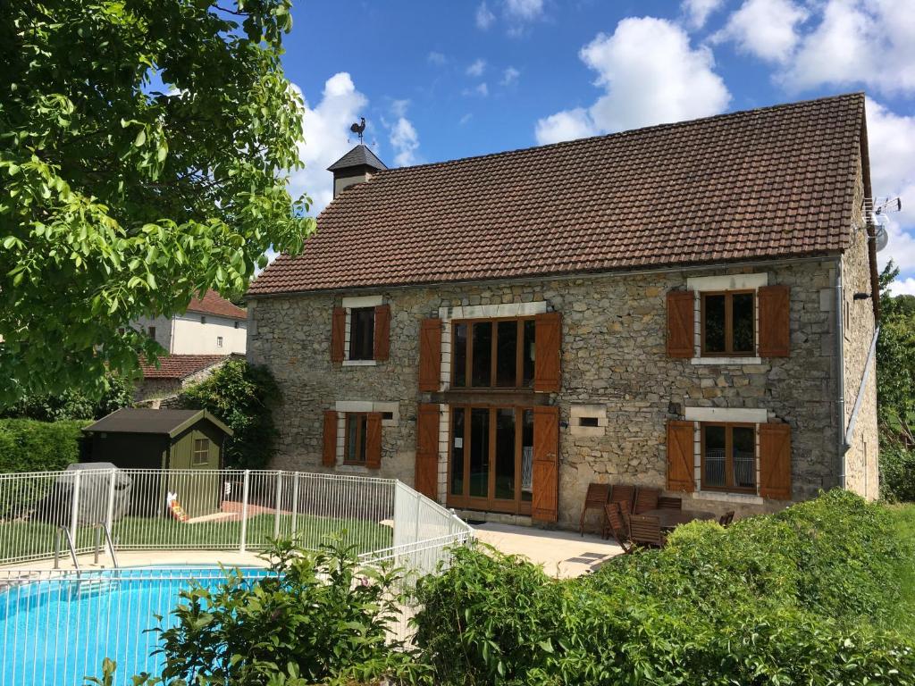a house with a swimming pool in front of it at La Grange Du Noyer in Cornac