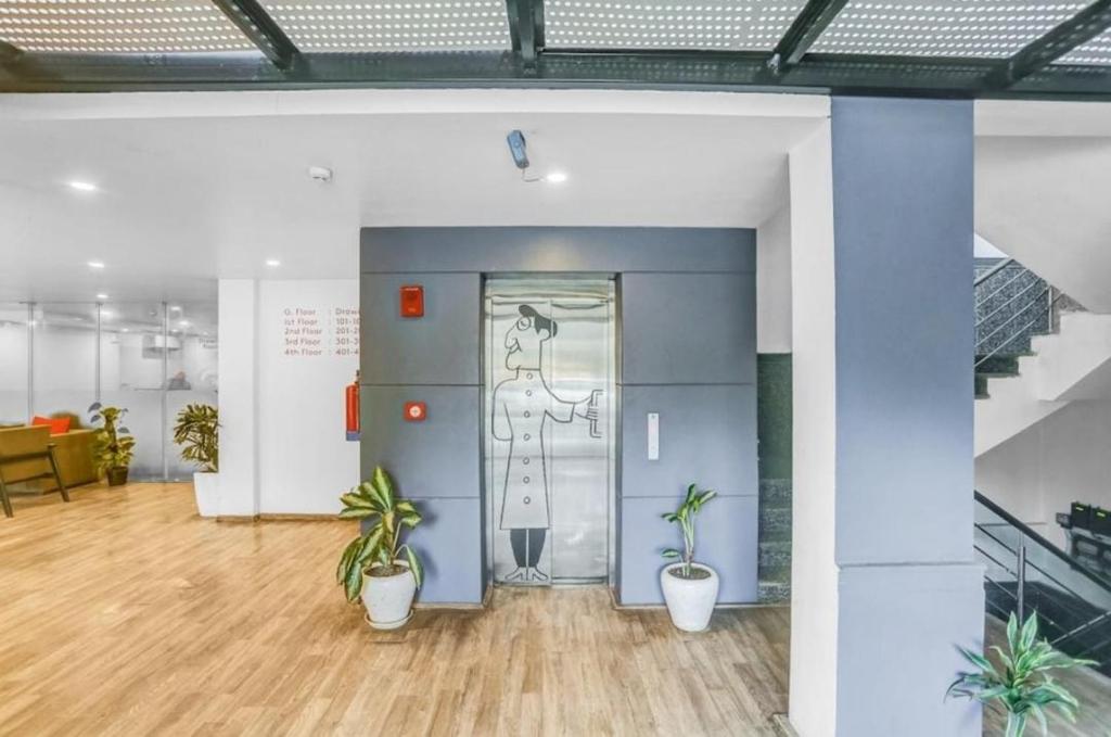 an office with potted plants in front of a door at Hotel Lavish Inn in Jāmb