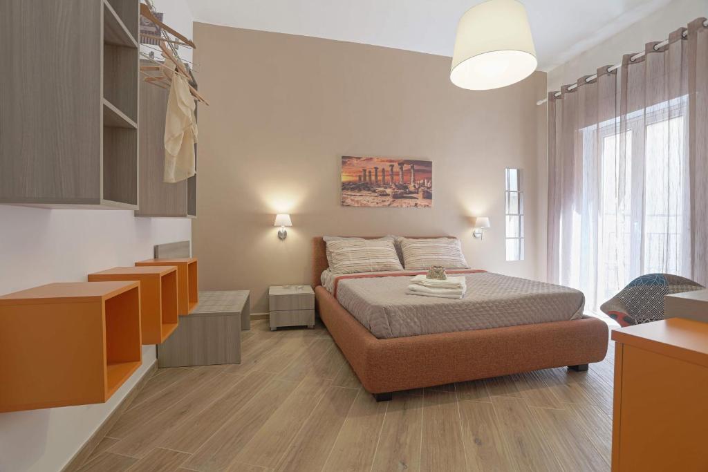 a bedroom with a bed and a large window at Le Maioliche in Agrigento