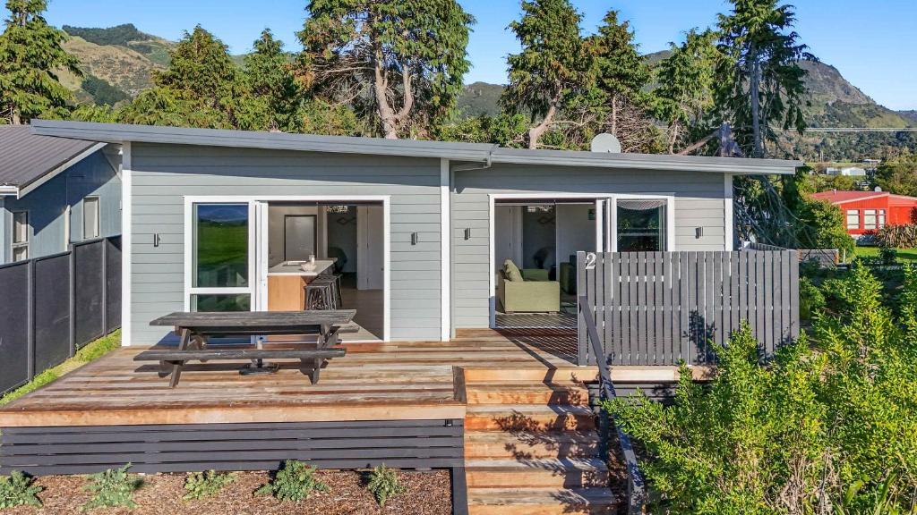 a tiny house with a deck with a picnic table at Sea Esta in Pohara