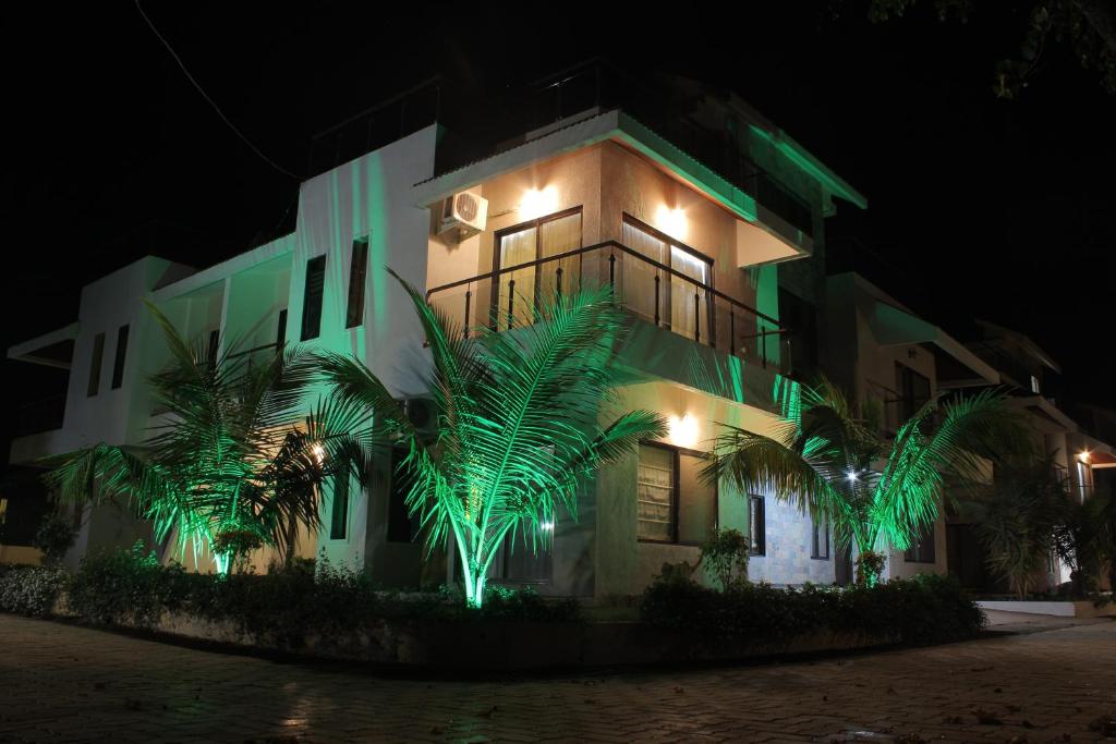 a building with green lights on it at night at Sia Resort in Nagaon