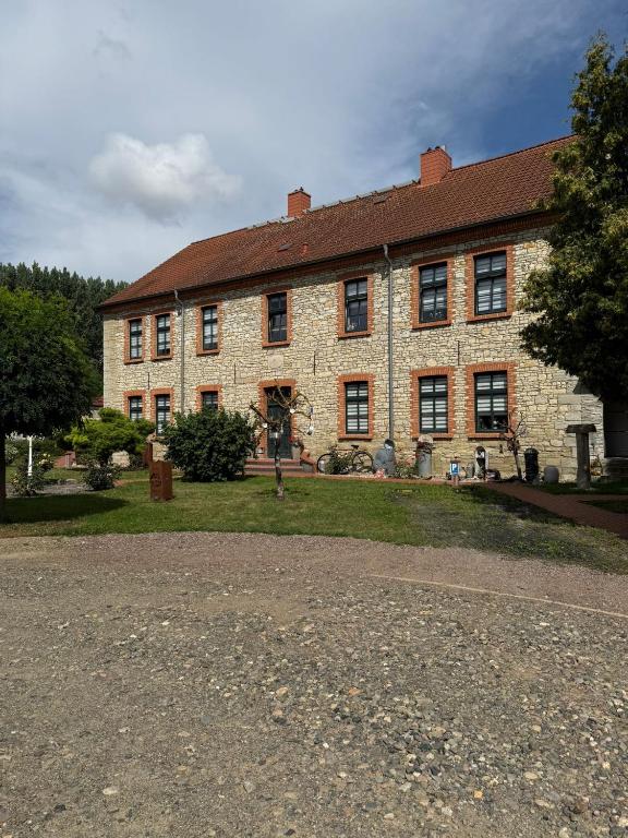 a large brick building with a yard in front of it at Fewo zum Klosterhof OG 2 in Nienhagen