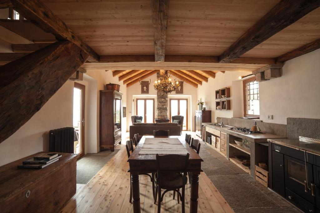 a kitchen with a wooden table in a room at Magica Vercio in Mergozzo