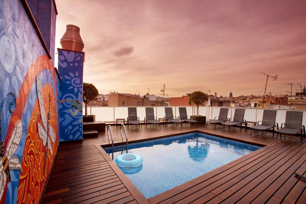 a swimming pool on the roof of a building at Ciutat de Barcelona in Barcelona