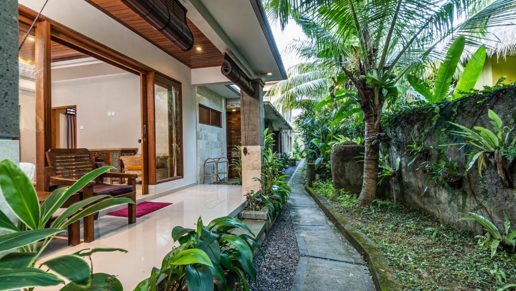 a house with a courtyard with trees and plants at Bendito Ubud in Ubud