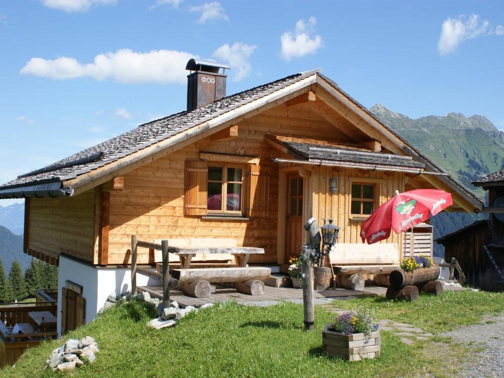 a log cabin with a picnic table in front of it at Chalet in Sankt Gallenkirch near Ski Bus in Sankt Gallenkirch