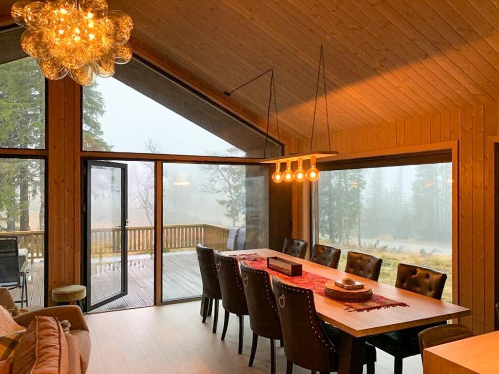 a dining room with a table and chairs at Modern Cabin Close To The Ski Slopes In Haglebu in Eggedal