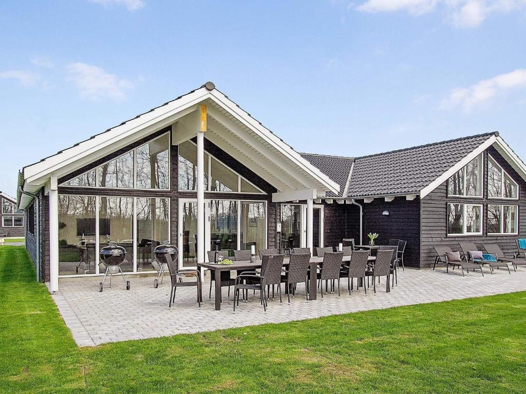 a house with a patio with a table and chairs at 18 person holiday home in Hasselberg in Kappeln