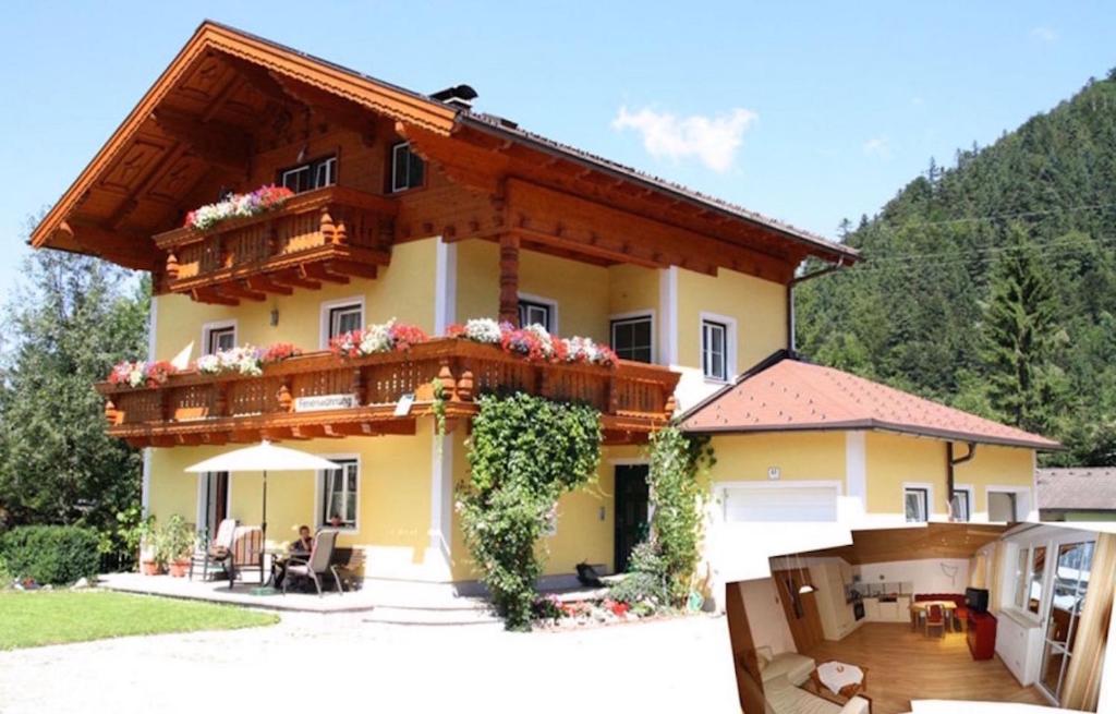 a house with a balcony with flowers on it at Haus Ebner Johann in Hintersee