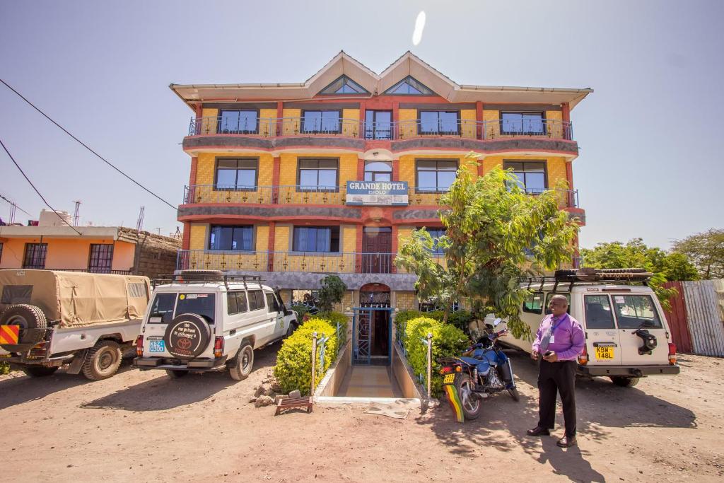 a woman is standing in front of a building at Grande Hotel in Isiolo