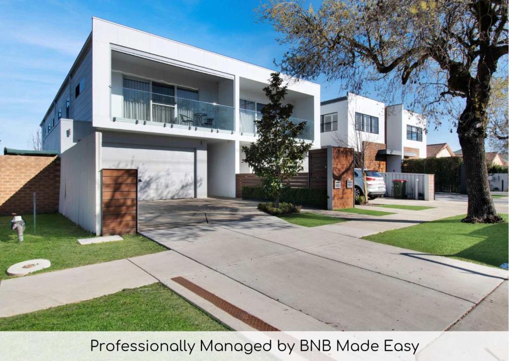 a large white house with at Forsyth Retreat - Modern Townhouse in Wagga Wagga