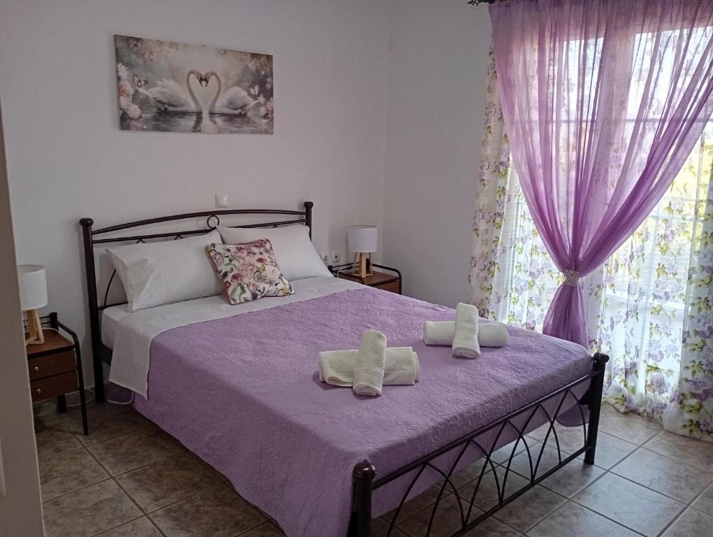 a bedroom with a bed with two towels on it at PENELOPE'S apartment in Kefalonia