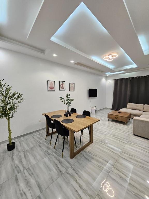 una sala de estar con una mesa y un sofá en Résidence Jordan, en Dakar