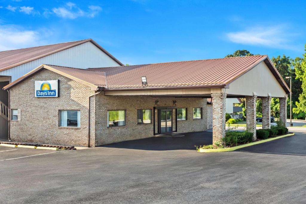 a front view of a building with a garage at Days Inn by Wyndham Huntington in Pea Ridge